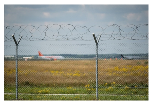 Airport Fencing with Planes in Background