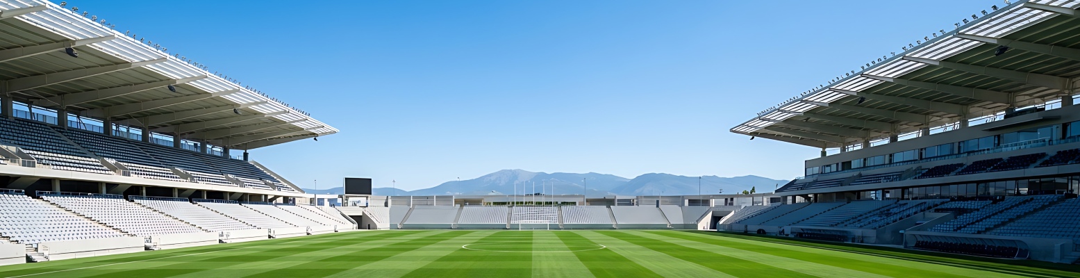 Empty soccer stadium with green pitch