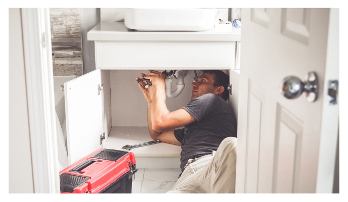 Man fixing sink plumbing