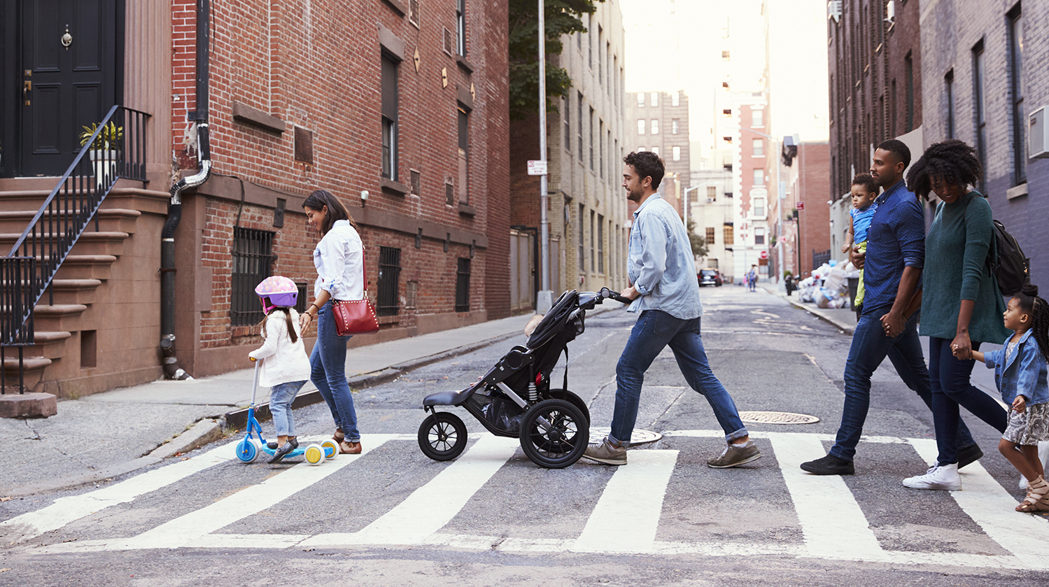 Two families with daughters crossing road