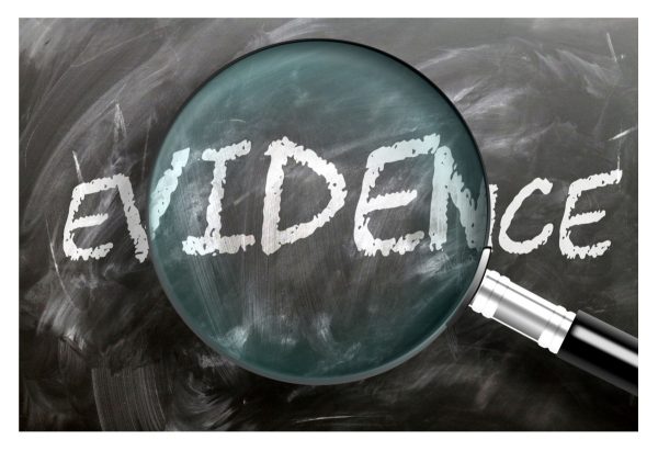 The word Evidence under a magnifying glass